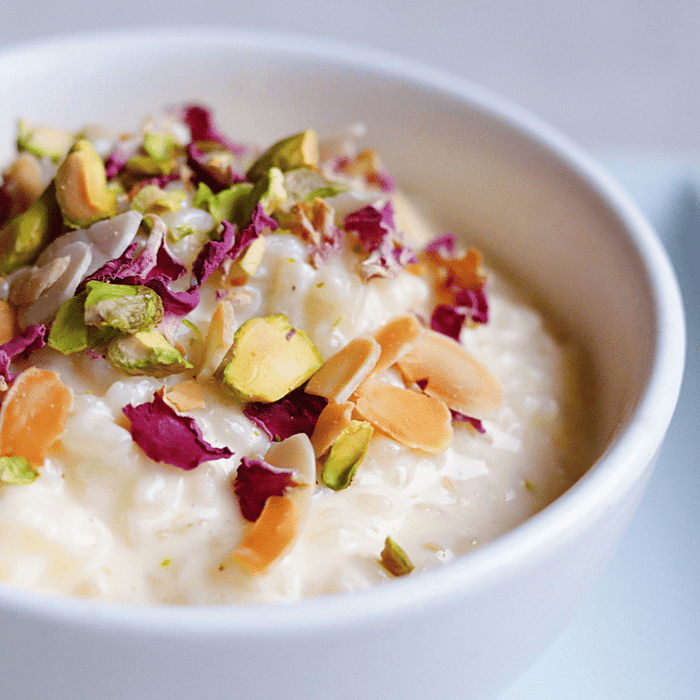 Coconut rice pudding with honey and pistachio crumble and florals